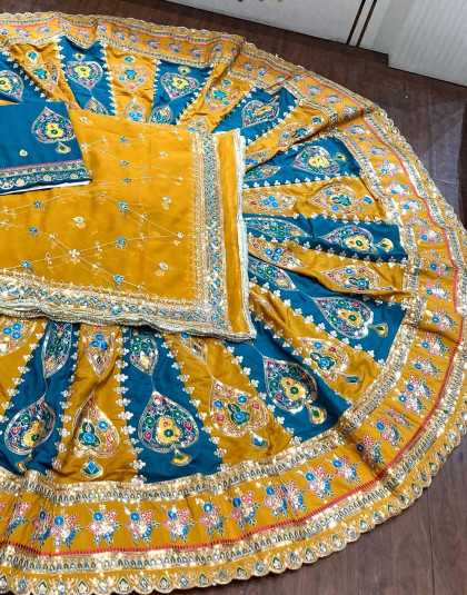 boutique poshak in peacock blue and yellow colors